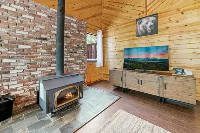 a living room with a fireplace and a flat screen tv at Hidden Spot - Desirable Fox Farm area of Big Bear in Big Bear Lake