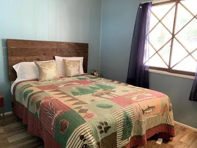 a bedroom with a bed with a quilt on it at Honey Bear - Close to lake and village in Big Bear Lake