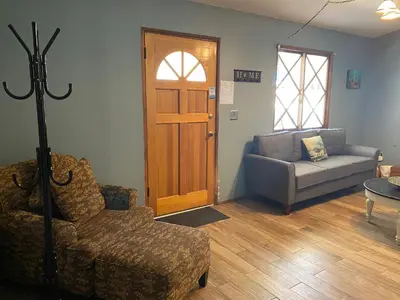 a living room with a couch and a chair and a door at Honey Bear - Close to lake and village in Big Bear Lake