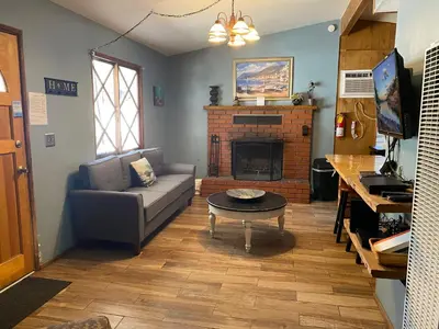 a living room with a couch and a fireplace at Honey Bear - Close to lake and village in Big Bear Lake