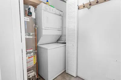 a refrigerator and a washer and dryer in a kitchen at Lakefront Retreat - Lakefront cabin near Holloways Marina in Big Bear Lake