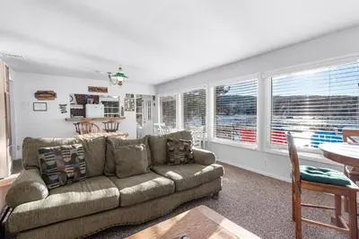 a living room with a couch and a table at Lakefront Retreat - Lakefront cabin near Holloways Marina in Big Bear Lake