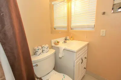 a bathroom with a toilet and a sink at Lakeview Court Castle - Short walk to the Village and lake in Big Bear Lake