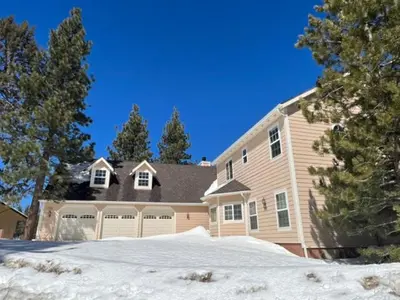 a large house with snow in front of it at Lakeview Court Castle - Short walk to the Village and lake in Big Bear Lake