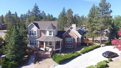 an aerial view of a house with a driveway at Lakeview Court Castle - Short walk to the Village and lake in Big Bear Lake