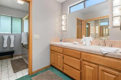 a bathroom with a large sink and a mirror at Lakeview Haven - Large cabin with game room close to the lake! in Big Bear Lake