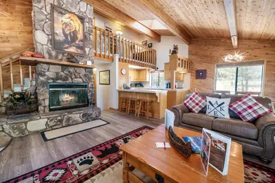 a living room with a couch and a fireplace at Lakeview Haven - Large cabin with game room close to the lake! in Big Bear Lake