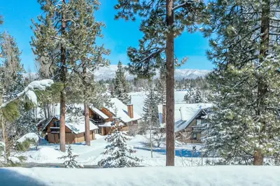 a log cabin in the woods in the snow at Lakeview Haven - Large cabin with game room close to the lake! in Big Bear Lake