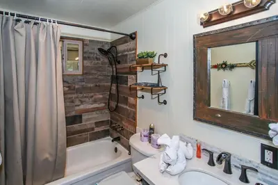 a bathroom with a tub and a sink and a mirror at Little Big Pine - Perfect, stylish cabin near the lake with a great deck in Big Bear Lake