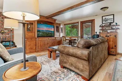 a living room with a couch and a table at Mallard Landing - Steps from the marina and minutes from the Village in Big Bear Lake