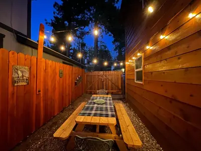 a room with a wooden fence and a picnic table at Mallard Landing - Steps from the marina and minutes from the Village in Big Bear Lake