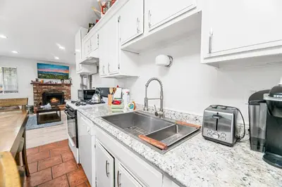 a kitchen with a sink and a counter top at Nunu's Cabin - Beautiful cabin, close to ski resorts and town, Hot Tub and Board Games! in Big Bear Lake