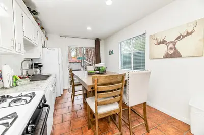 a kitchen with a table and chairs in a kitchen at Nunu's Cabin - Beautiful cabin, close to ski resorts and town, Hot Tub and Board Games! in Big Bear Lake
