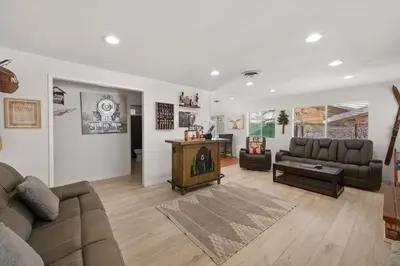 a living room with a couch and a table at Nunu's Cabin - Beautiful cabin, close to ski resorts and town, Hot Tub and Board Games! in Big Bear Lake