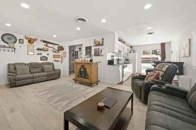 a living room with a couch and a table at Nunu's Cabin - Beautiful cabin, close to ski resorts and town, Hot Tub and Board Games! in Big Bear Lake