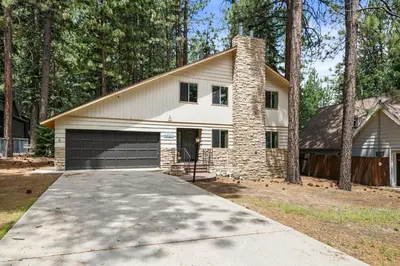 a house with a garage and a driveway at Sky Krest - Located on a quiet street in the middle of town, Games! Pool table! in Big Bear Lake