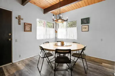 a dining room with a wooden table and chairs at Sky Krest - Located on a quiet street in the middle of town, Games! Pool table! in Big Bear Lake