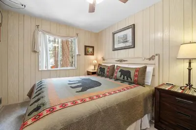 a bedroom with a bed and a window at Sky Krest - Located on a quiet street in the middle of town, Games! Pool table! in Big Bear Lake