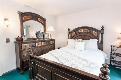 a bedroom with a large bed and a mirror at Snow Summit Getaway - Walk to Snow Summit Ski Resort in Big Bear Lake