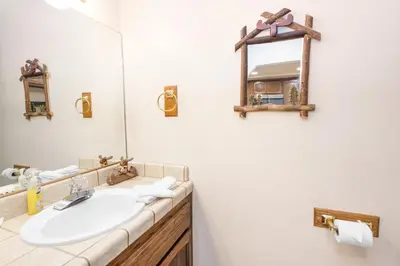 a bathroom with a sink and a mirror at Snow Summit Getaway - Walk to Snow Summit Ski Resort in Big Bear Lake