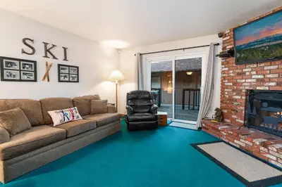 a living room with a couch and a fireplace at Snow Summit Getaway - Walk to Snow Summit Ski Resort in Big Bear Lake
