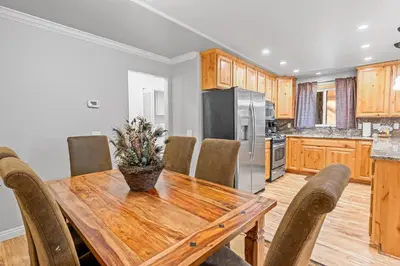 a kitchen with a wooden table and chairs at Summit Condo - Luxury condo, walk to the slopes! in Big Bear Lake