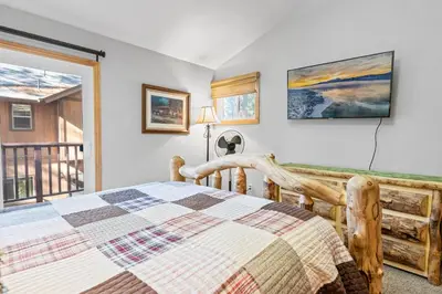 a bedroom with a bed and a balcony at Summit Condo - Luxury condo, walk to the slopes! in Big Bear Lake