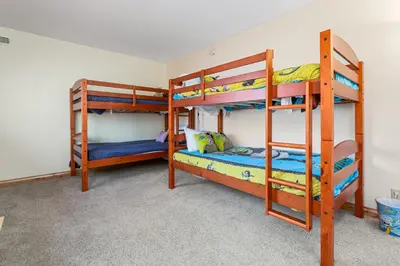 a bedroom with two bunk beds and a bunk bed at Whiskey Pines Chalet - Warm and cozy cabin with modern features made more fun with a gameroom in Big Bear Lake