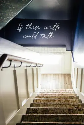 a staircase with a sign that reads if these walls could talk at The Richland in Orange