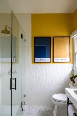 a bathroom with a toilet and a tv on the wall at The Richland in Orange