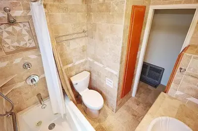 a small bathroom with a toilet and a shower at Stylish 4 Bedroom Home Near Venice Beach with Backyard BBQ in Los Angeles