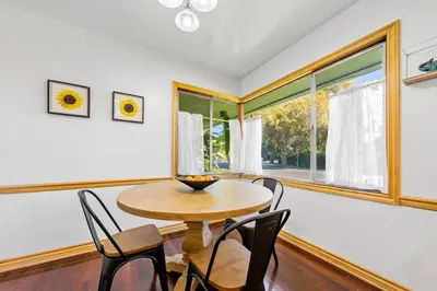 a dining room with a table and chairs and a window at Spacious pool home in Pasadena in Pasadena