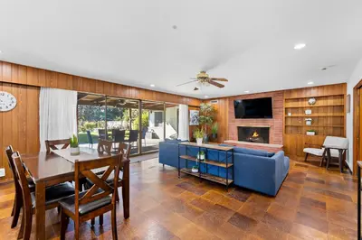 a living room with a table and a blue couch at Spacious pool home in Pasadena in Pasadena