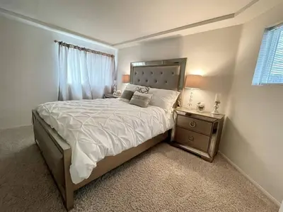 a bedroom with a large bed and a night stand at Beach House located in quiet community. in Oxnard