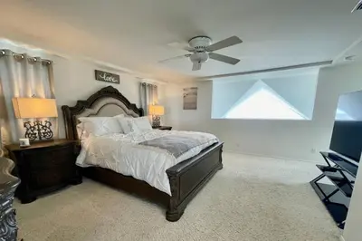 a bedroom with a bed and a ceiling fan at Beach House located in quiet community. in Oxnard