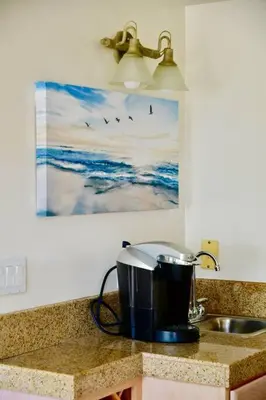 a kitchen counter with a sink and a pot on a counter at Beach House located in quiet community. in Oxnard