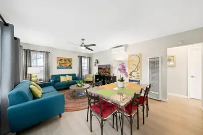 a living room with a blue couch and a table at Spacious Centrally Located NEW 2 Bedroom Property! in Inglewood