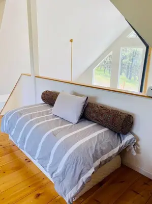 a small bed in a room with a window at Modern House on 5 acr in Sequoia National Forest in Panorama Heights