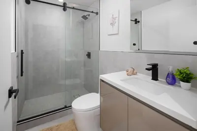 a bathroom with a shower and a toilet and a sink at Modern Hollywood Charm in Los Angeles
