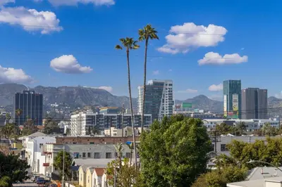 a city skyline with palm trees and buildings at Modern Hollywood Charm in Los Angeles
