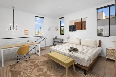 a bedroom with a bed and a desk and a desk at Modern Hollywood Charm in Los Angeles