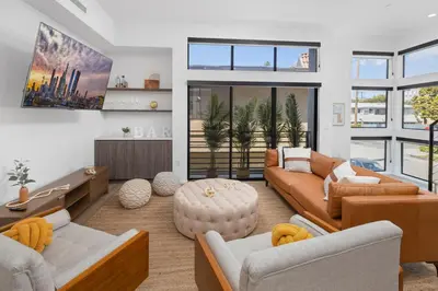 a living room with two couches and a table at Modern Hollywood Charm in Los Angeles