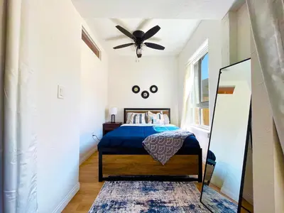 a bedroom with a bed with a ceiling fan at Heart of Hollywood Apartment - 2Bed 2Bath in Los Angeles