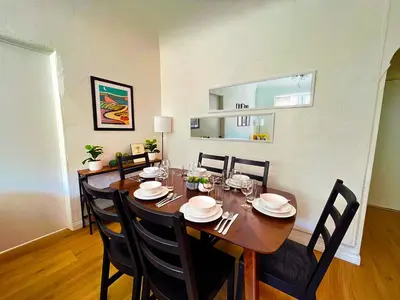 a dining room with a wooden table and chairs at Heart of Hollywood Apartment - 2Bed 2Bath in Los Angeles