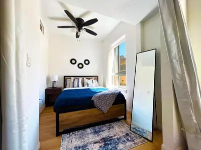 a bedroom with a bed with a ceiling fan at Heart of Hollywood Apartment - 2Bed 2Bath in Los Angeles