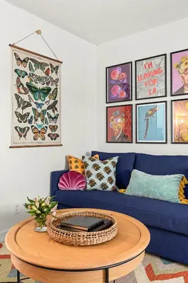 a living room with a blue couch and a table at East Village Arts District, King Suite with Sofa Bed NRP23-01221 in Long Beach