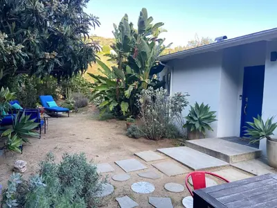 a patio with a blue door and some plants at Stunning Hollywood Midcentury Modern-Views-Best Location! in Los Angeles
