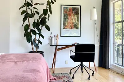 a bedroom with a desk and a chair and a plant at Stunning Hollywood Midcentury Modern-Views-Best Location! in Los Angeles
