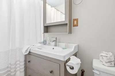 a bathroom with a sink and a mirror and a toilet at Village and Lake Escape - Walk to the Lake and Village in Big Bear Lake