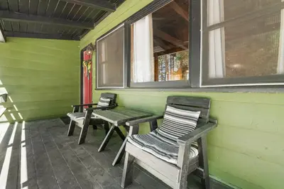a porch with two chairs and a table and a bench at Village and Lake Escape - Walk to the Lake and Village in Big Bear Lake